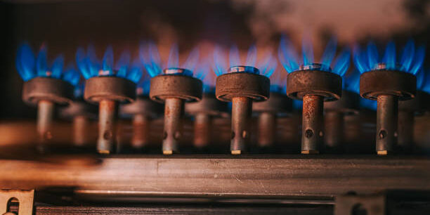 Fire on gas stove with dark background