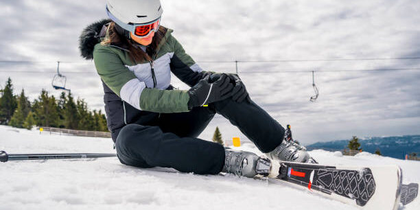 Young woman fell down on mountain slope