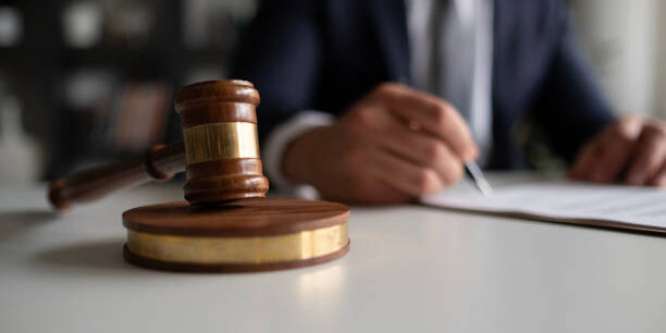 Judge or Legal advisor lawyer examining and signing legal documents.